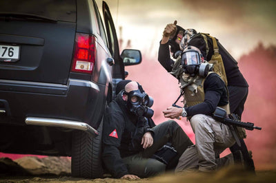 Solider treating a man wearing the CM-6M tactical gas mask