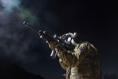 Soldier aiming down his rifle sights while wearing the MIRA Safety CM-7M military gas mask